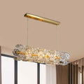 A modern decorbites™ postmodern brass pendant lamp with a gold frame and crystal hexagon shade for restaurant lighting