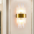 Postmodern gold-toned wall sconce with clear fluted crystal rods and a circular base designed for 110v-120v use