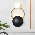 Postmodern orbital flush mount black and gold sconce with illuminated white globe and matte black shade for bedroom wall