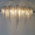 Decorbites postmodern silver lobby chandelier features an arch aluminum chain with cascading glass prisms and 220v-240v 110v-120v compatibility