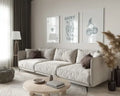 Beige upholstered sectional sofa with soft rounded armrests in modern minimalist design beside hearts wall art set