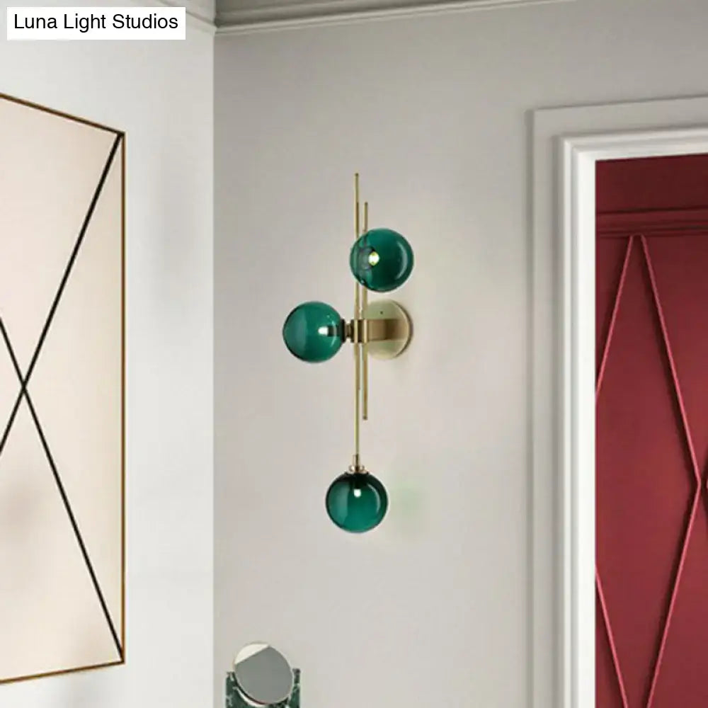 Retro brass wall sconce with 3 glass globes for dining room