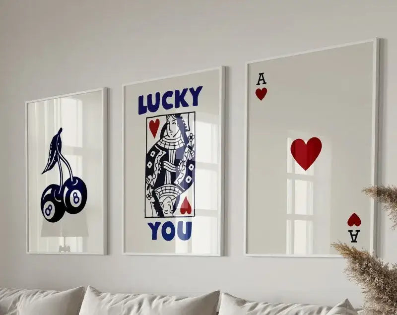 Set of three framed retro wall art posters featuring queen of hearts playing card and cherry motifs in navy blue red and white