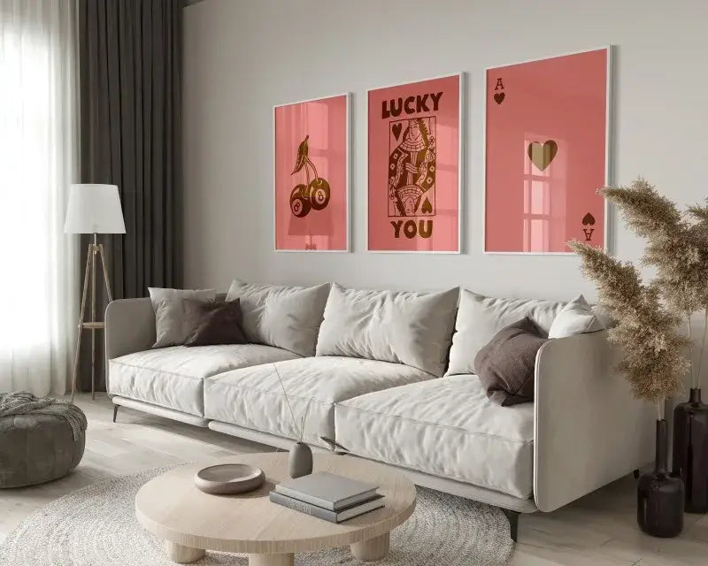 Decorbites™ retro wall art posters set with queen of hearts theme displayed above a modern beige sectional sofa with dark gray pillows