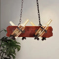 Rustic island lamp with brown wood arm featuring frosted white and amber glass wine bottles on dark chains