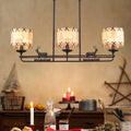 Rustic black metal deer chandelier with three cream fabric cylindrical lampshades in barrel shade shape for dining room