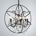 Black wrought iron chandelier pendant with clear crystal deco droplets and candle-style bulbs for restaurant decor