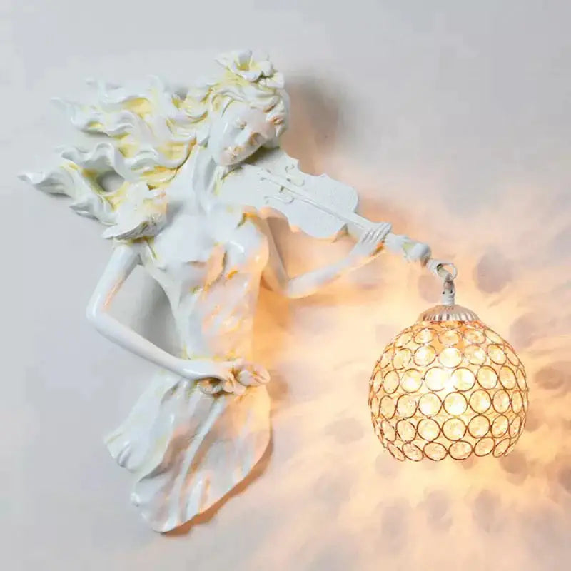White ceramic wall lamp featuring a sculpted violinist with flowing hair and an ornate crystal wall lampshade