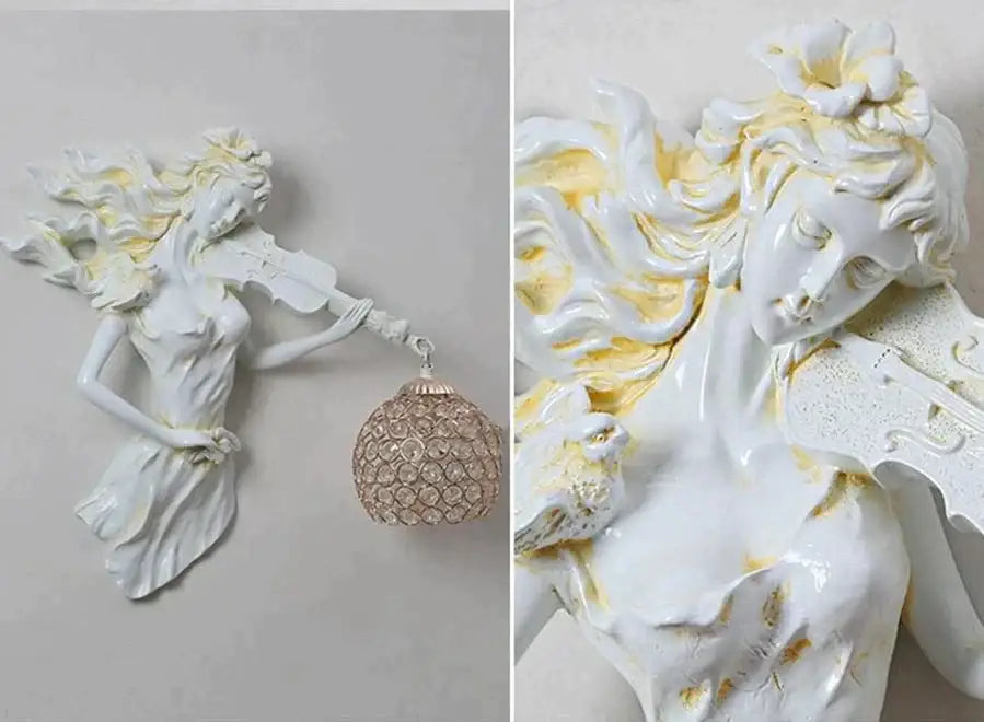 White ceramic wall lamp of a gold-accented violinist holding an ornate crystal pendant for living room sconce