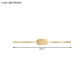 A sleek gold metallic wall mounted vanity sconce with a simple style and oval central accent for bedroom use