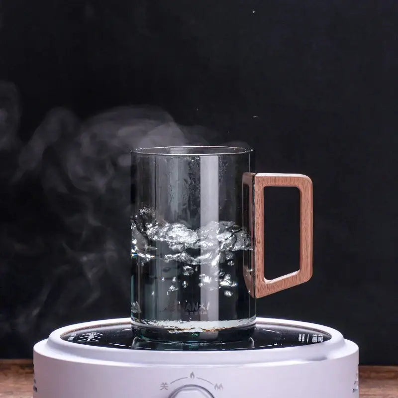 Sleek dark gray double walled glass tea cup with wooden lid kitchen