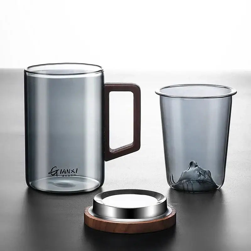 Sleek dark gray double walled glass tea cup with wooden lid kitchen