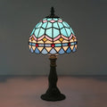A tiffany stained glass table lamp with a dome shade in blue pink gold and red beads 110v-120v for bedroom use