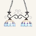 DecorBites stunning Tiffany-style pendant light with blue and white stained glass and ornate black metal arms
