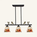 Black antique brass chandelier with three stained glass sunflower shades and bird accents in tiffany style design