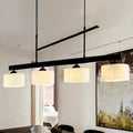 Decorbites 4-light traditional drum island pendant in black with four off-white fabric shades for dining room lighting