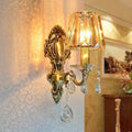 Traditional brass wall lamp with clear crystal shade living room