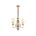 Traditional gold and blue chandelier with metal frame and ceramic orbs as dining room light with shades