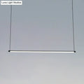 Minimalist black ultra slim tube led office hanging lamp with frosted glass diffuser providing warm white light for dining rooms