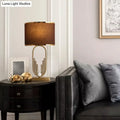 Vintage gold metal table lamp with brown fabric shade for study room