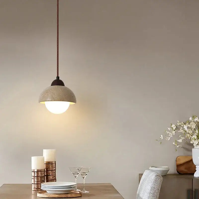 Warm textured concrete cave stone pendant light dining room