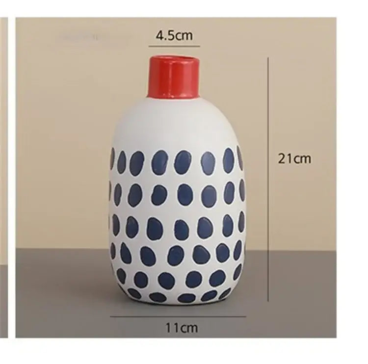 White ceramic polka dot vase with colorful graffiti lines living room